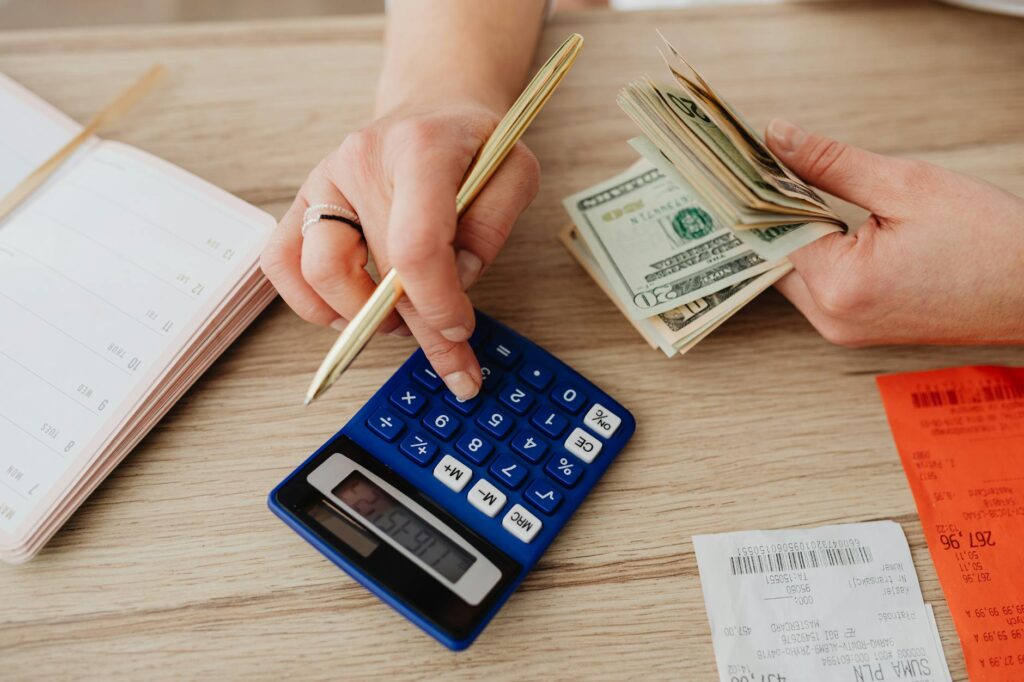 A person organizing money and financial documents on a desk, representing various budgeting methods for beginners.