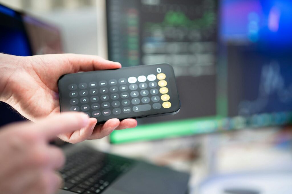 Person using an electricity bill calculator to estimate utility costs and manage energy consumption