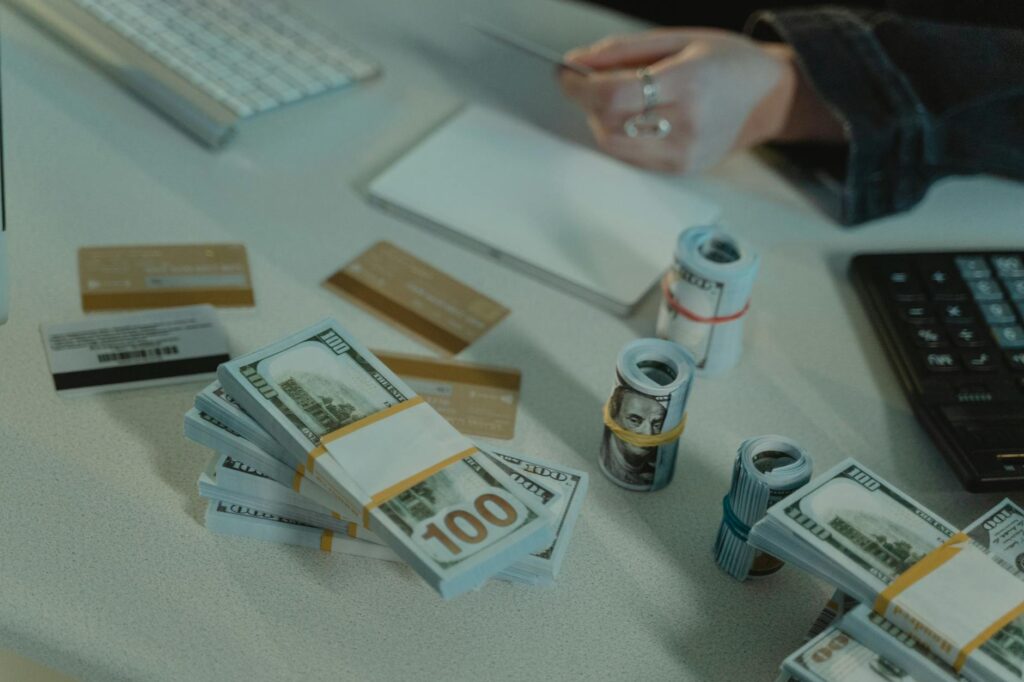 A person using a credit card interest calculator to understand their debt interest, with a credit card and financial documents on a desk.
